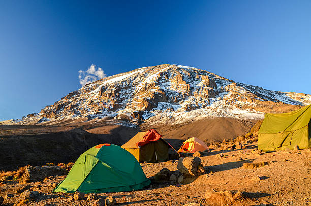 Stunning evening view of Kibo with Uhuru Peak (5895m amsl, highest mountain in Africa) at Mount Kilimanjaro,Kilimanjaro National Park,seen from Karanga Camp at 3995m amsl. Tents in the foreground.