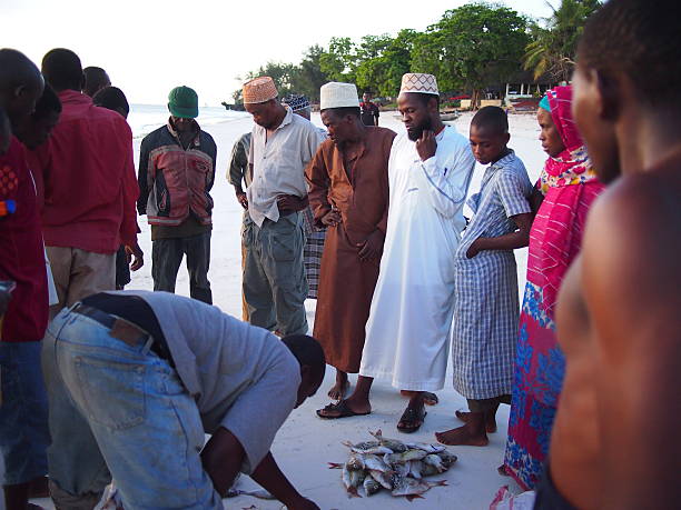 Zanzibar cultural insights fishermen in Kizimkazi Zanzibar selling fresh catch and speaking Swahili showcasing local coastal culture