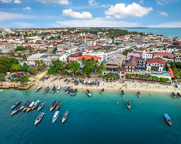 Zanzibar cultural insights aerial view of Stone Town Zanzibar showing historic architecture dhow boats and Indian Ocean coastline