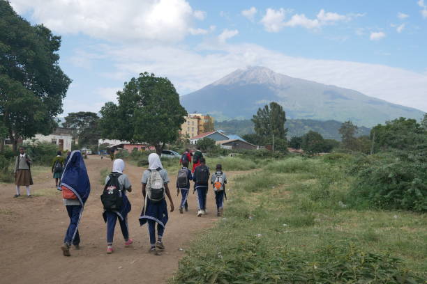 Arusha City Guide – boys and girls walking home from school in Arusha, Tanzania with Mount Meru in the background, showcasing daily life and culture in Arusha City