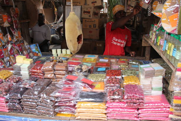 Zanzibar Spice Tours experience featuring a vendor selling spices at Darajani Market in Stone Town Zanzibar, showcasing local spice trade and culture